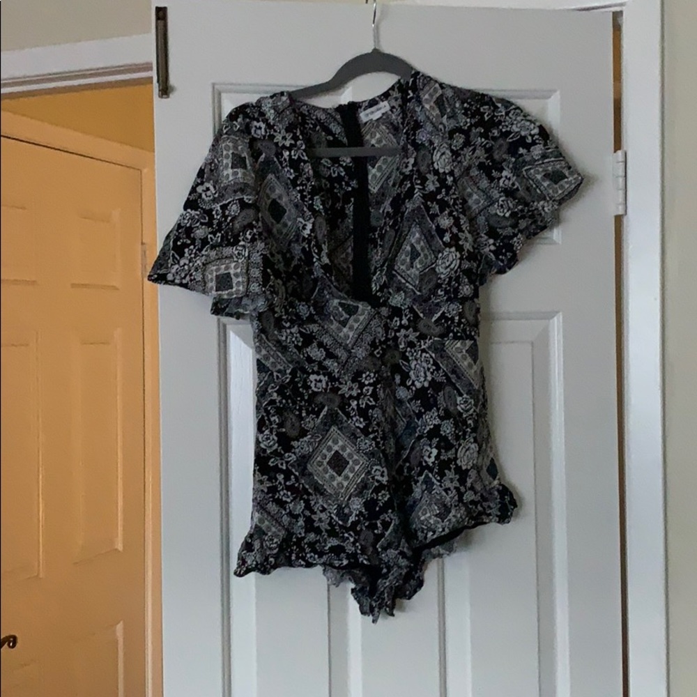 Playsuit with ruffle around legs.